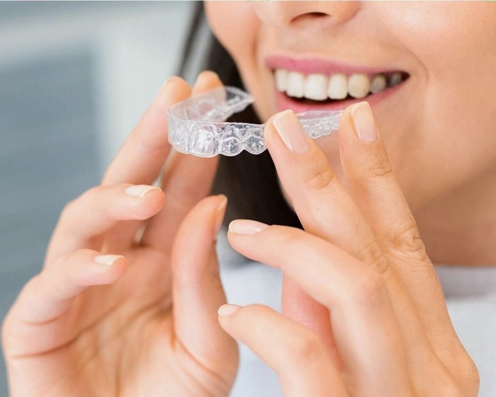 Woman putting in a clear aligner